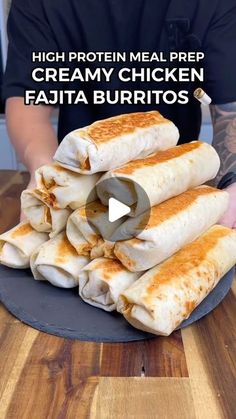 a person is holding a plate with burritos stacked on top of each other and the words high protein meal prep creamy chicken fajita burritos