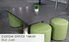 an office table with three stools and a potted plant on it in the middle