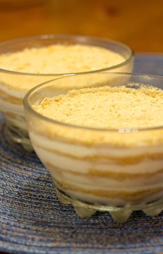 two dessert dishes sitting on top of a blue plate