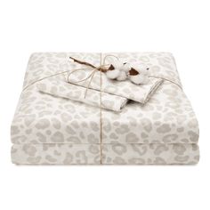 two sheets with white and brown animal print on them