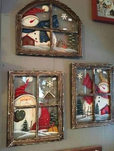 two framed snowmen are on the wall next to each other in front of a window