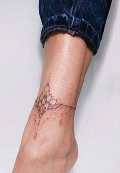 a woman's foot with a flower tattoo on the left side of her leg