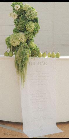 an arrangement of flowers and fruit on display in a bathtub