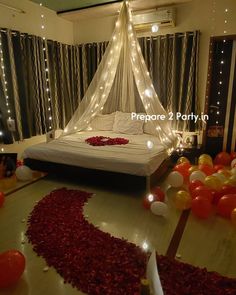 a bedroom decorated with balloons and lights for a wedding or special occasion to the couple