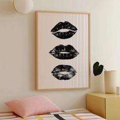 three lips are shown on the wall above a bed