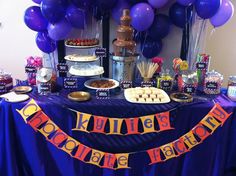 a table topped with purple balloons and desserts