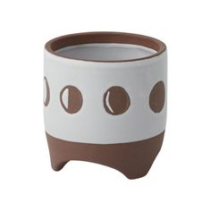 a brown and white pot with circles on it