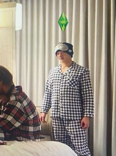 two men in pajamas and hats standing next to each other