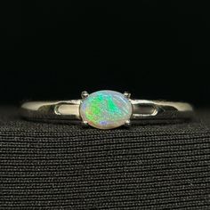 An Exquisite Saturated Opal Face Filled With Bright Color Set In An Ordinary Simple Sterling Silver Ring. Type - Dark Location - Lightning Ridge Weight - 0.30 Cts Size - 6mm X 4mm X 2mm Pattern - Sheen Cut - Oval Brightness - B3 Metal - .925 Sterling Silver Size - Adjustable You Can View A Full Video With Discounts At - Https://Www.Theopalsource.Com/Product-Page/The-Green-Sheen-Machine-925-Sterling-Silver-Lightning-Ridge-Opal-Ring Dark Location, Sterling Silver Rings Simple, Lightning Ridge Opal, Lightning Ridge, Ring Color, Opal Ring, Opal Rings, Bright Color, Color Set