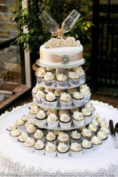 a wedding cake made out of cupcakes on top of a table