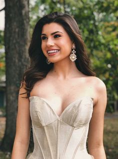 a woman in a white corset posing for the camera