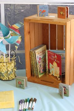 there are many books on display in the book stand with markers and crayons