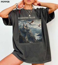 a woman wearing a black tshirt with an image of a castle on it