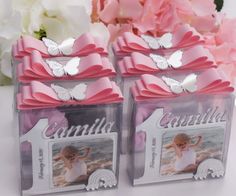 two clear boxes with pink bows and butterflies on them