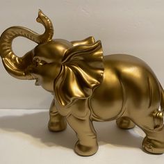 an elephant figurine made out of shiny gold foil