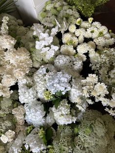 a bunch of white flowers sitting on top of a table