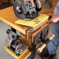 a person using a sanding machine on top of a workbench with measurements