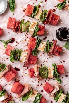 watermelon, cucumber and prosciutto skewers on white paper