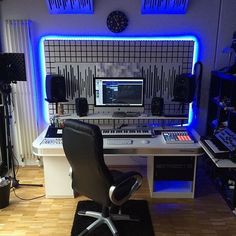 a home recording studio with multiple monitors and equipment