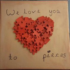 a heart made out of puzzles on a piece of wood that says, we love you to pieces