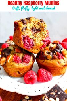 raspberry chocolate chip muffins on a plate with fresh raspberries