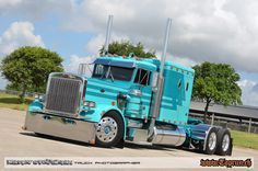 a large blue semi truck parked in a parking lot