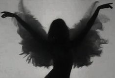 the silhouette of a woman with angel wings on her body is shown in black and white