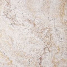 a close up view of a white marble textured wall or floor with yellow and brown streaks