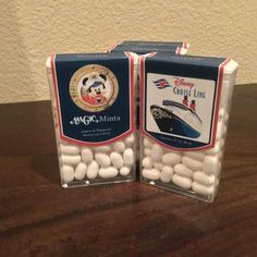 two packages of disney cruise mints sitting on top of a wooden table next to each other