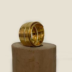 "This gold-filled multiband statement ring is an impressive and meaningful piece for everyday wear and special occasions.  It features an engraving of the Woman of Valor (Eshet Chayil) psalm of praise for the ideal woman. The husband sings this psalm to his wife on Sabbath Eve, Queen Sabbath, in tribute and love.  The psalm is an acrostic - every first letter in verse creates the entire Hebrew alphabet, from the letter 'Aleph' to 'Tav.' Rich with a romantic sentiment, this makes an excellent gif Spiritual Yellow Gold Engraved Ring In Brass, Spiritual Yellow Gold Engraved Brass Ring, Spiritual Engraved Yellow Gold Ring In Brass, Spiritual Brass Engraved Ring, Spiritual Gold Etched Rings, Spiritual Etched Gold Rings, Gold Wide Band Stackable Rings Gift, Gold Etched Brass Rings, Gold Engraved Etched Ring For Ceremonial Use