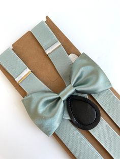 "This trendy and stylish bow tie and suspenders set is great for so many occasions! Bow tie made of silky satin fabric with a matching, adjustable neck strap.  All our bow ties can be made in the following sizes, just specify which size you need in a note at checkout:  Sizes: Kids (2-6y) 4\" x 2\" Youth (7-12 y): 4.5\" x 2.25 Adult (13 y and older) 5\" x 2.5\" All our bow ties are made by hand; therefore, measurements are a guideline only and cannot be guaranteed.  Neck strap sizes: Baby - adjus Elegant Suspenders For Party Suit Accessories, Elegant Adjustable Belts And Suspenders For Wedding, Elegant Fitted Belts And Suspenders With Bow, Elegant Adjustable Belts And Suspenders For Black Tie, Elegant Belts And Suspenders As Gift, Elegant Party Belt With Bow, Groomsmen Suspenders And Tie, Wedding Bow Tie With Butterfly Knot, Green Satin Bow Tie