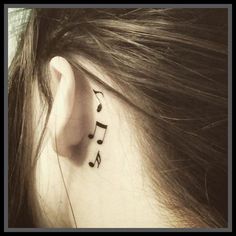 a woman's ear with musical notes on it