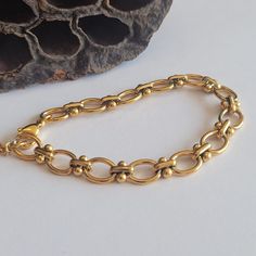 Embrace the charm with our exquisite O-Shaped Dot Bracelet. Crafted with precision, this retro-inspired bracelet features a delightful combination of 18k gold and stainless steel, resulting in a timeless piece of jewelry. The O-shaped dot design adds a touch of elegance and uniqueness, making it a perfect accessory for any occasion. The adjustable length of 6-8.5 inches ensures a comfortable and personalized fit for every wrist. Whether you're attending a party or simply looking to enhance your everyday style, this bracelet is a versatile choice. Its retro aesthetic adds a touch of nostalgia and sophistication to any outfit. As a thoughtful gift, this bracelet is sure to impress, capturing the essence of both style and sentiment. Elevate your jewelry collection with this vintage-inspired O Dainty Gold Oval Bracelets, Gold-tone Oval Bracelets For Gifts, Handmade Gold Oval Bracelets, Handmade Oval Gold Bracelets, Yellow Gold Metal Charm Bracelet, Gold Jubilee Bracelet Oval Shape, Oval Gold Plated Bracelet For Gift, Gold Oval Jubilee Bracelet, Handmade Gold Link Bracelets