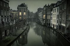 a river running through a city next to tall buildings