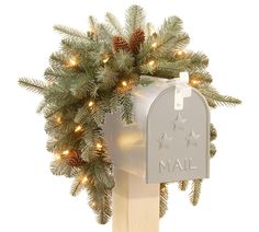 a mailbox decorated with pine cones and lights