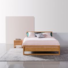 a bed sitting on top of a white floor next to a wooden dresser and nightstand