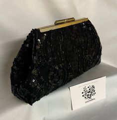 Your wedding or special occasion outfit will be complete, with this small black sequin lace evening bag clutch purse handbag.  The black sequin lace mesh is overlaid on black dupioni satin.  The 5 1/2" frame is available in gunmetal black or light gold hardware, and it has chain loops for an optional 18" chain strap attachment.     Height is 4 1/2", length at top is 5 1/2", length at bottom is 9", and it expands to a width of 2" at the bottom.   The clutch has body and stands by itself.  This cl Elegant Embellished Evening Bag For Night Out, Elegant Rectangular Sequin Clutch, Black Evening Bags With Sequins, Black Rectangular Evening Bag For Gala, Elegant Rectangular Evening Bag With Sequins, Black Sequined Bags For Formal Occasions, Black Embellished Evening Bag For Weddings, Formal Black Bag With Sequins, Elegant Embellished Evening Bag For Party Season