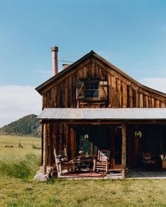 an old wooden house with a metal roof