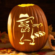 a carved pumpkin with an image of a man in a hat on it's face