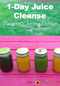 four jars filled with liquid sitting on top of a pink bench next to a green field