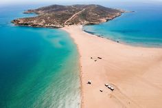 an aerial view of boats on the beach