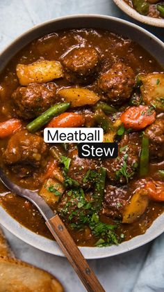 meatball stew with carrots, green beans and peppers in a bowl next to bread