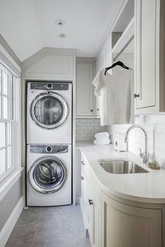 a washer and dryer in a white kitchen