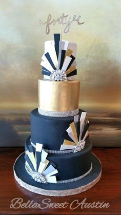 a three tiered blue and gold wedding cake