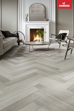 a living room filled with furniture and a fire place next to a white wall mounted fireplace