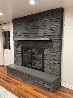 a stone fireplace in the corner of a room