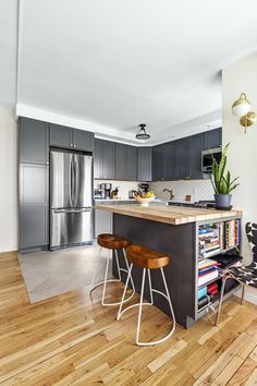 a kitchen with wooden floors and stainless steel appliances