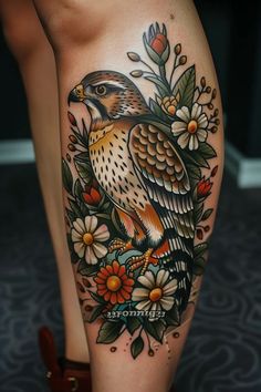 a woman's leg with flowers and a bird on it