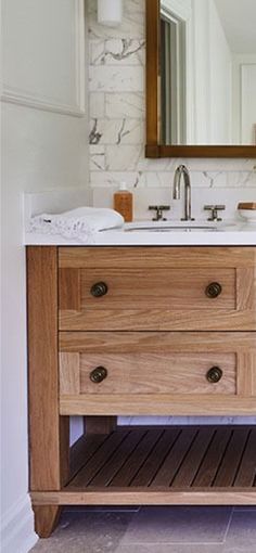 a bathroom vanity with two drawers and a mirror