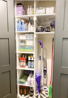 the closet is full of cleaning supplies and other household care products, including a vacuum cleaner